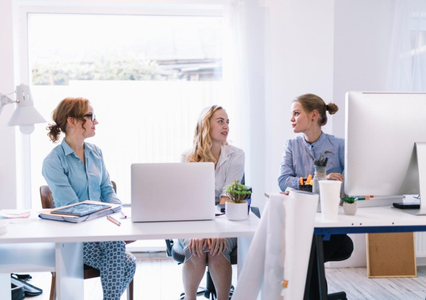 Collaborative financial planning session with detailed analysis documents